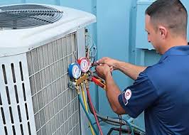 HVAC technician using refrigerant gauges during system maintenance